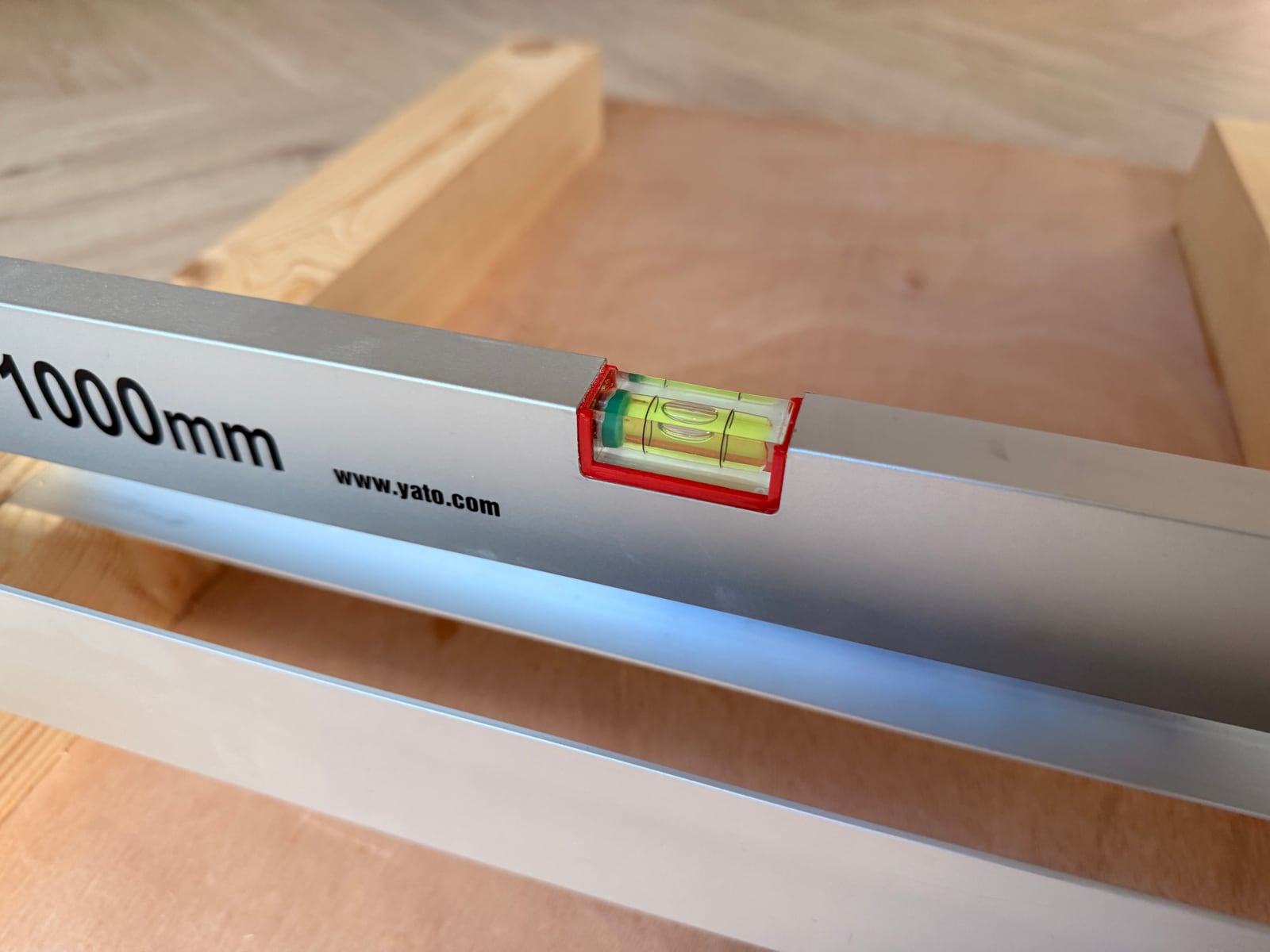 A 1000mm level lying across the sled rails