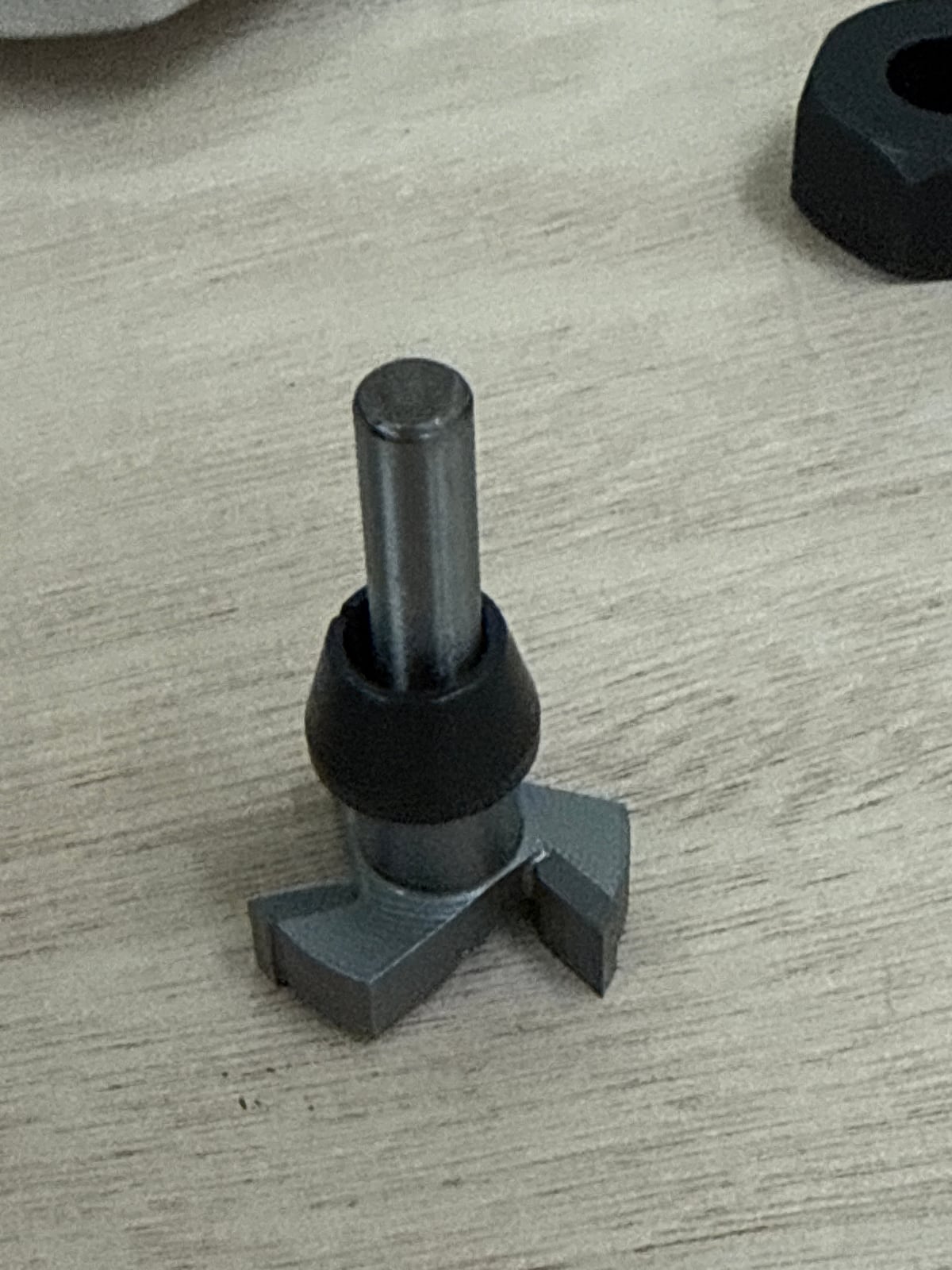 The surfacing bit standing upright with a small black collet on its shank
