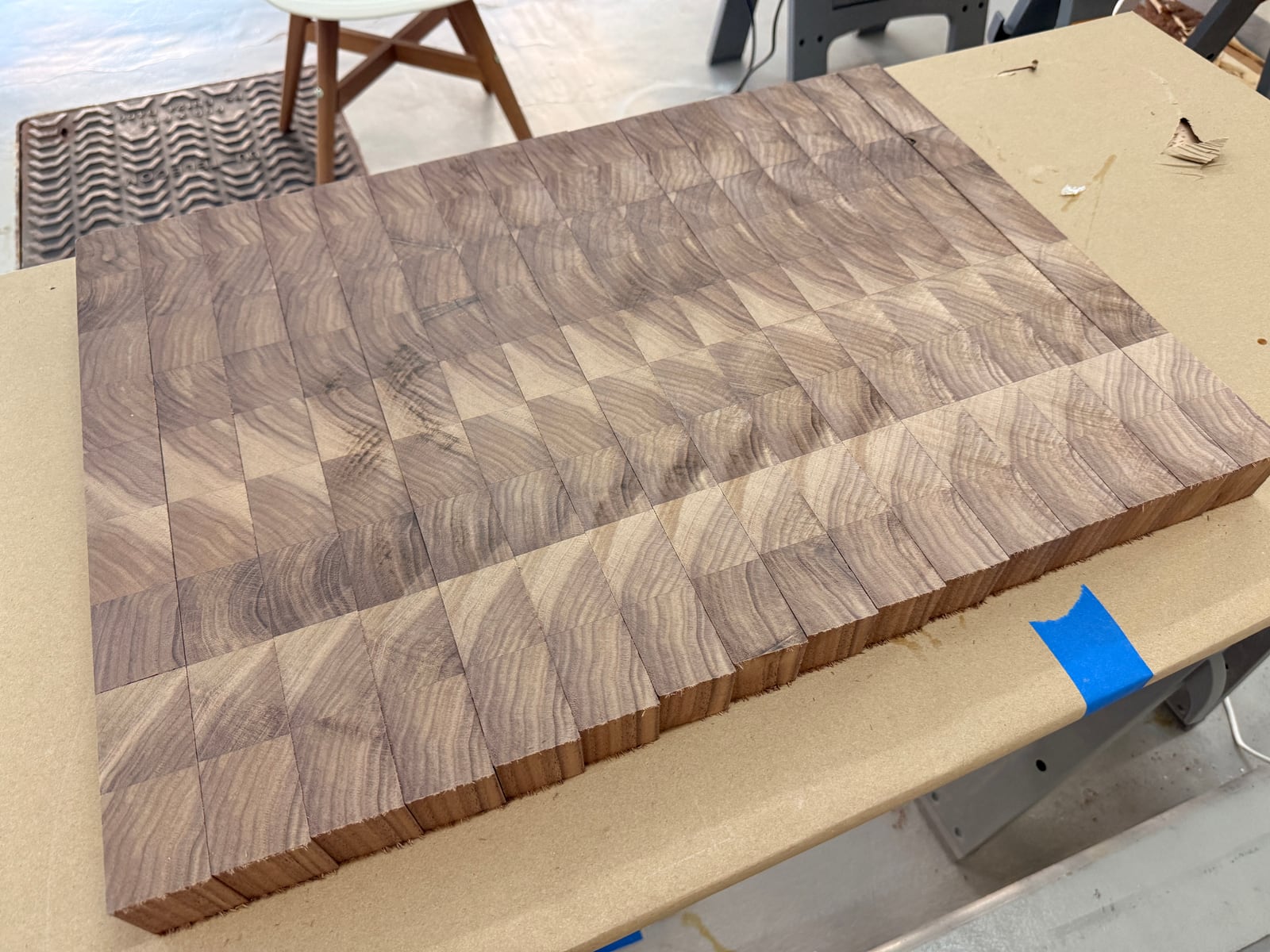 End grain walnut pieces arranged in a pattern on the bench