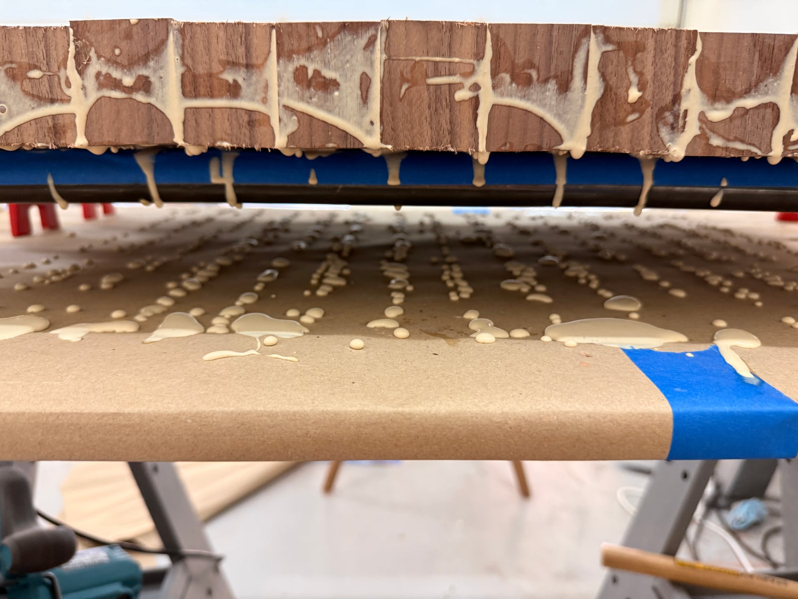 A closer view of glue dripping from the clamped board
