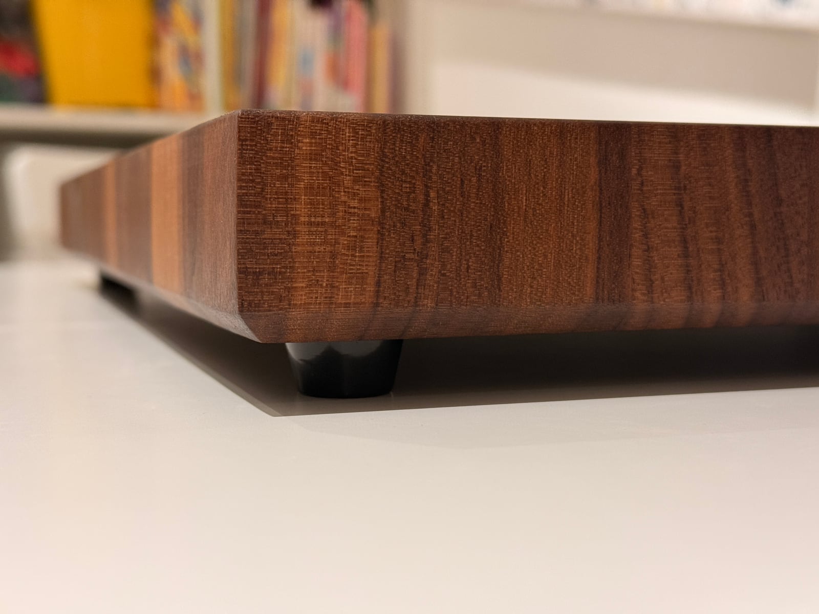 A low close-up of the board's oiled edge and rounded-over corner