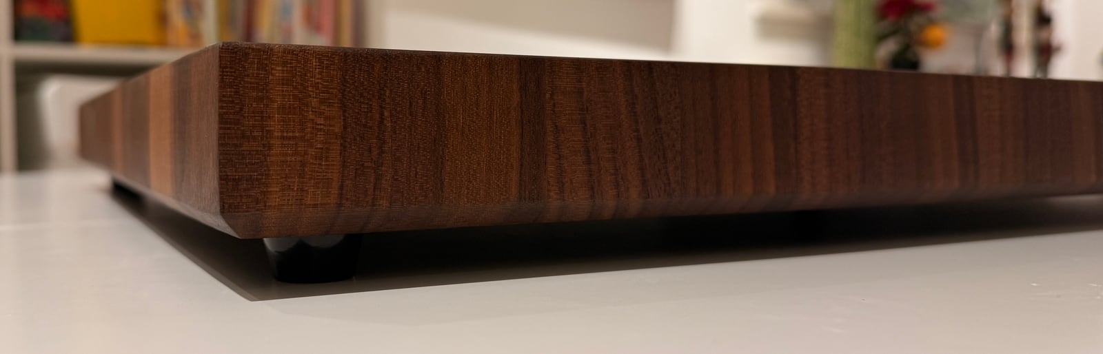 A side view of the thick walnut board sitting on its feet