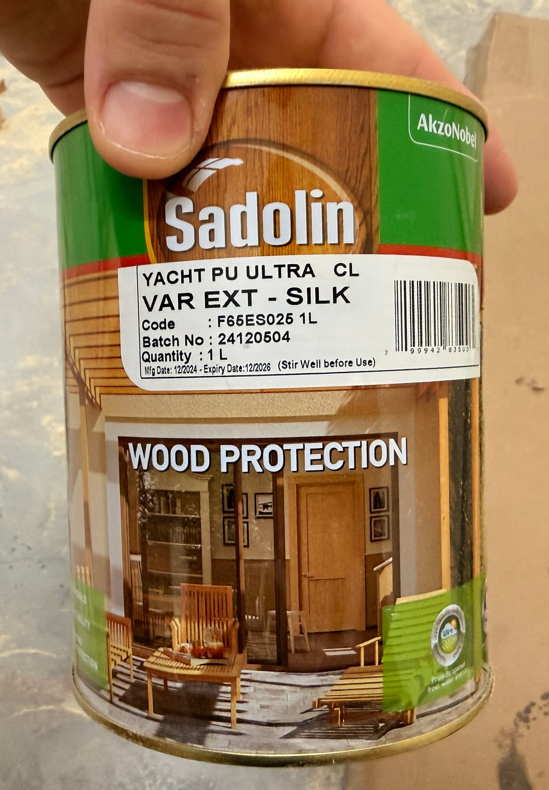 A tin of Sadolin Yacht PU Ultra silk varnish held up in the garage