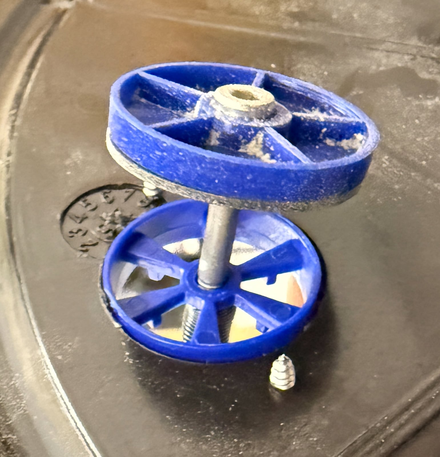 The underside of a bucket lid with an anti-crush valve fitted