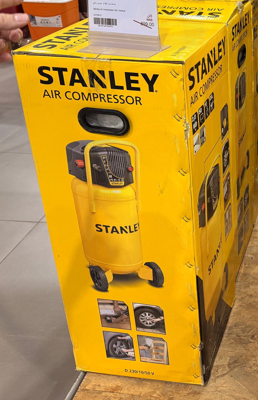 A boxed Stanley 50 litre vertical air compressor in a hardware store