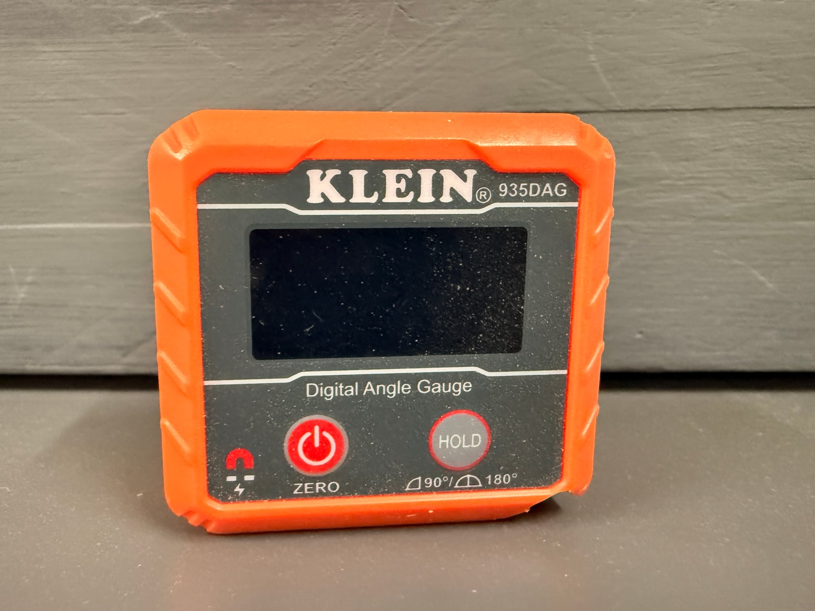 A magnetic digital angle gauge. The base magnets let it sit on a saw blade or table while you read the tilt.