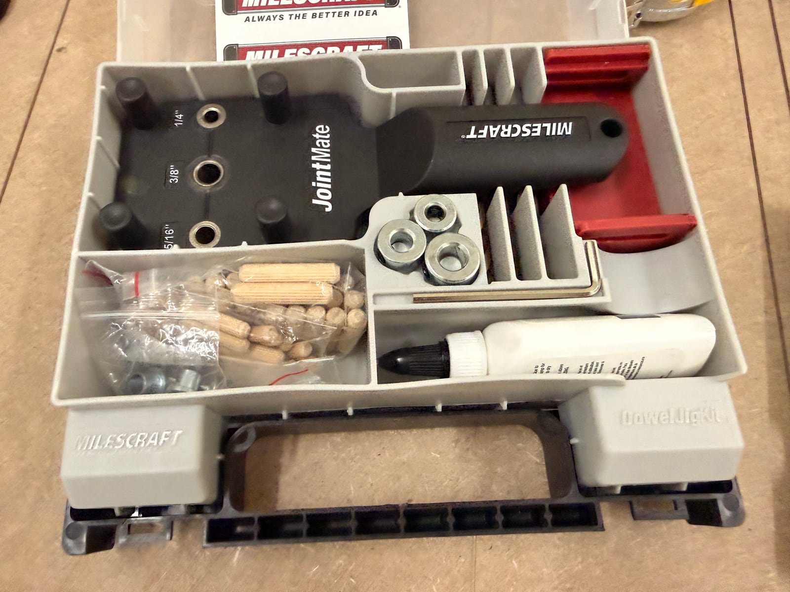 A doweling jig kit -- jig body with sized bushings, dowel centres, dowels and glue.
