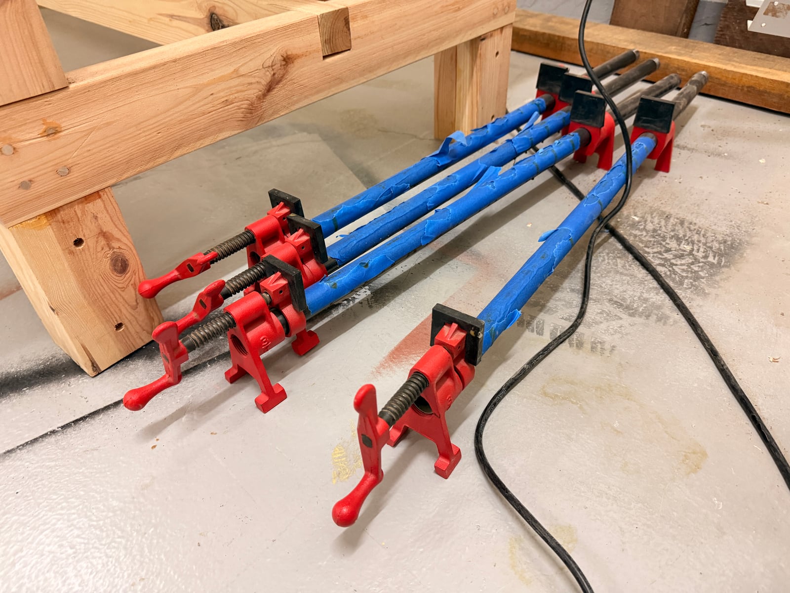 Pipe clamp fixtures on 3/4in black pipe. The fixtures are the product you buy; the pipe is whatever length you need, which is why these scale so cheaply.