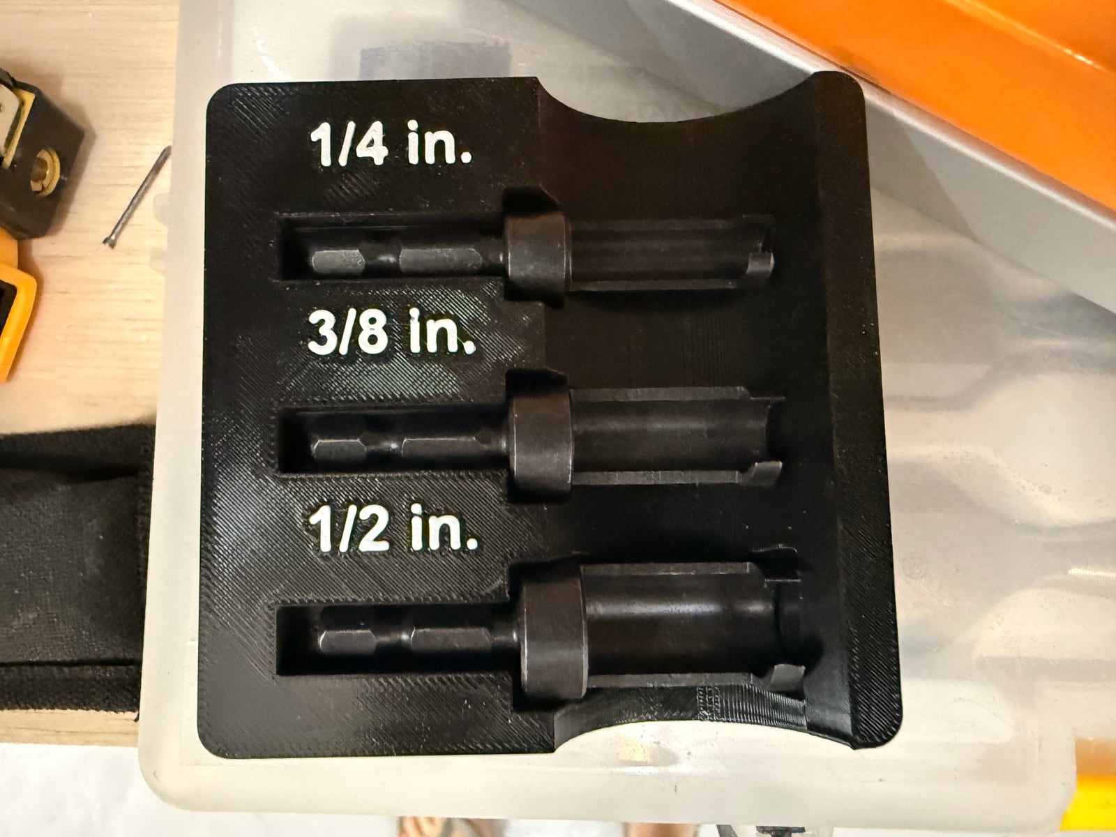 A set of plug cutters in 1/4in, 3/8in and 1/2in, in a printed holder.