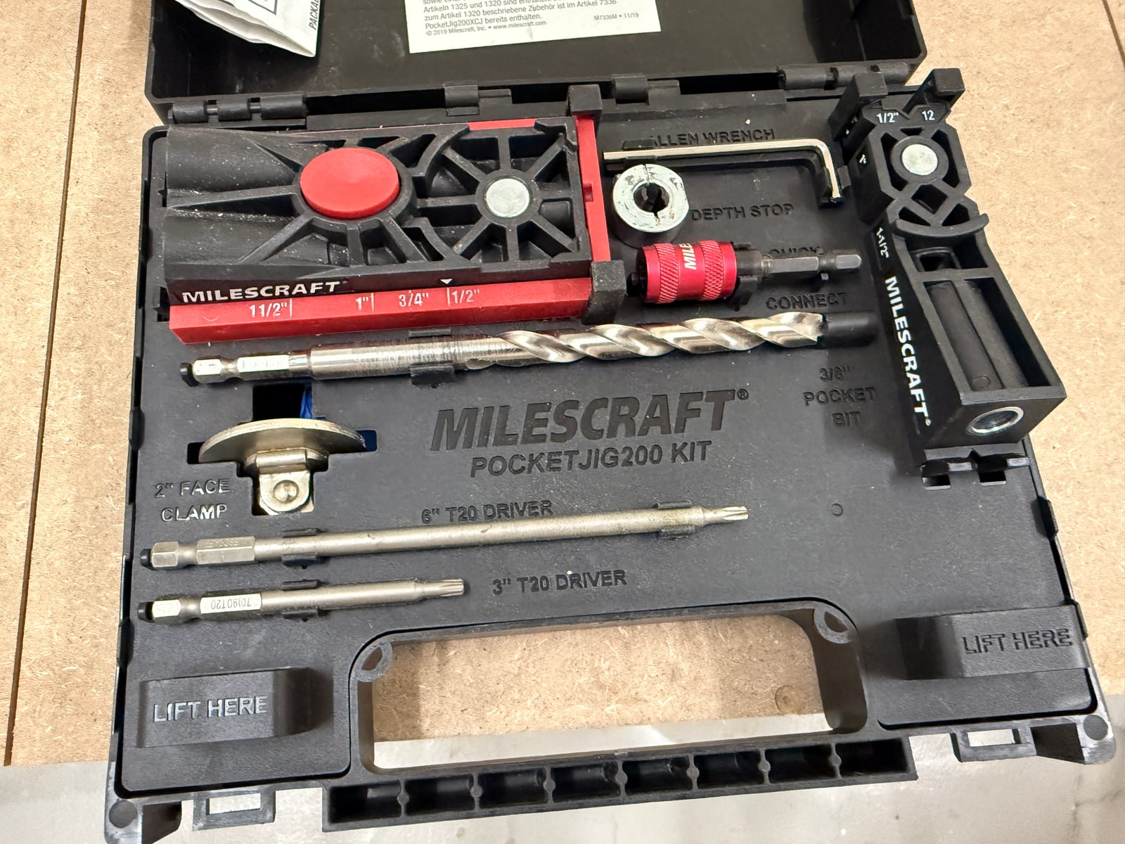 A Milescraft PocketJig200 kit -- jig body, stepped drill bit with depth collar, square-drive bits and a face clamp.