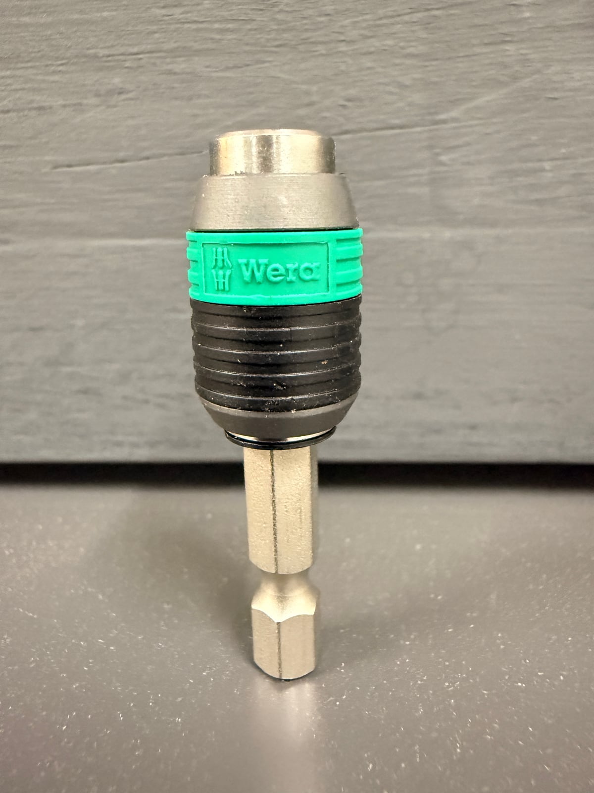 A quick-release bit holder. Pulling the knurled collar back releases the bit; the sleeve holds it magnetically and concentrically.