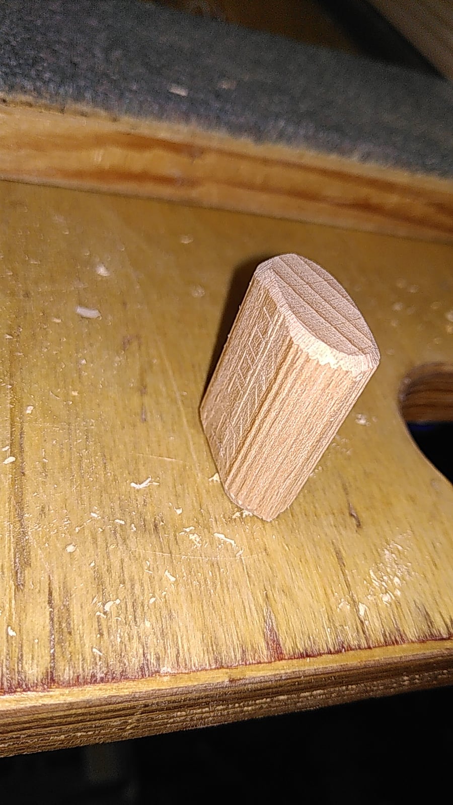 A loose Domino tenon. A stubby beech floating tenon with rounded ends, sized to the slot the machine cuts.