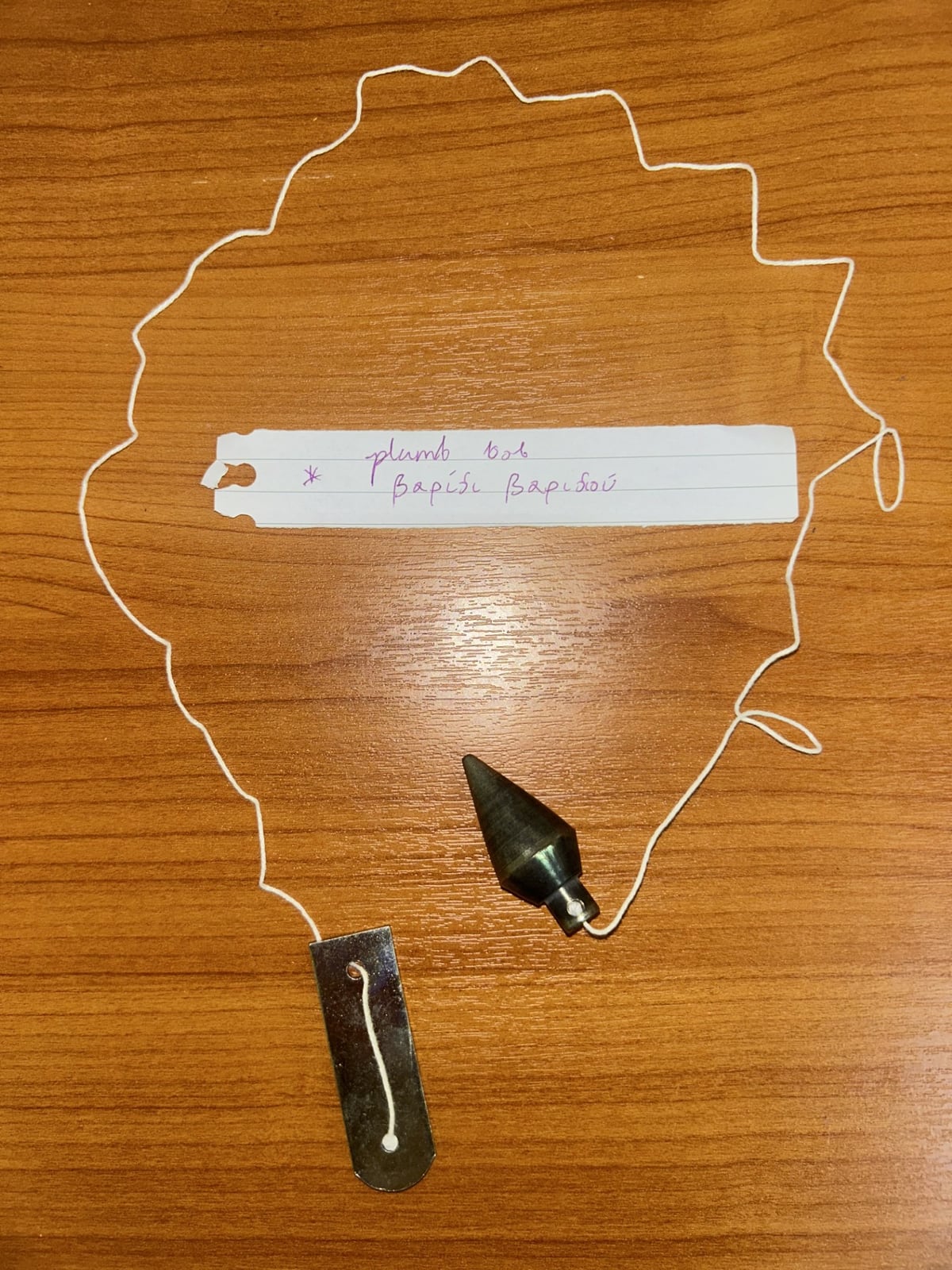 A plumb bob, used to check true vertical