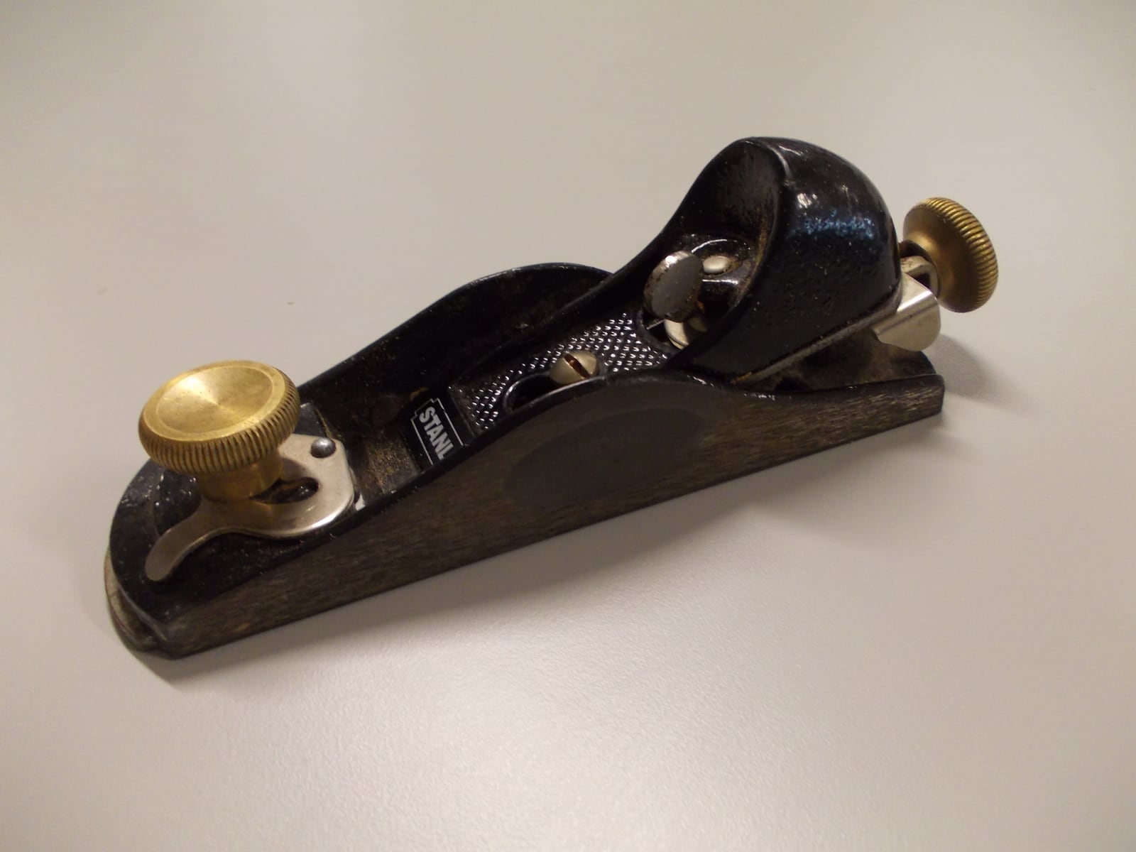 A block plane. Low-angle blade, bedded bevel up, small enough for one hand -- the plane most people reach for to break an edge or trim end grain.