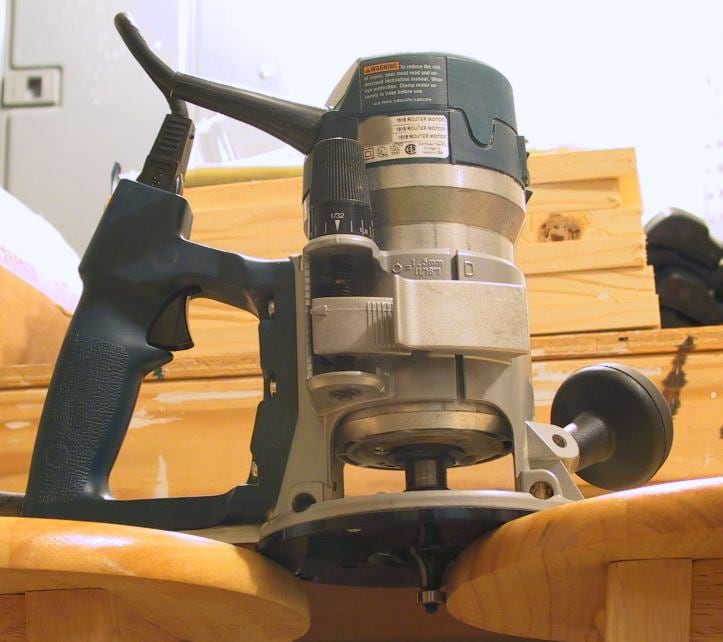 A wood router with the router bit visible