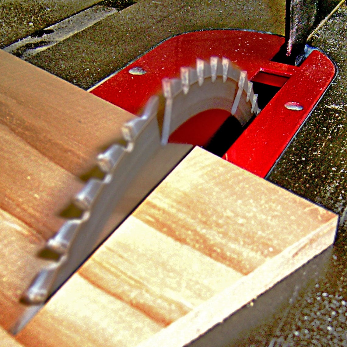 A table saw blade cutting wood at an angle