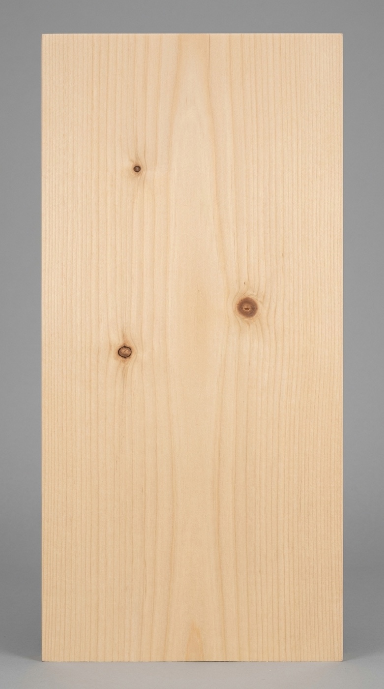 A board of Eastern White Pine -- pale creamy straw color, fine straight grain with soft low-contrast growth rings and the small tight knots typical of select-grade stock