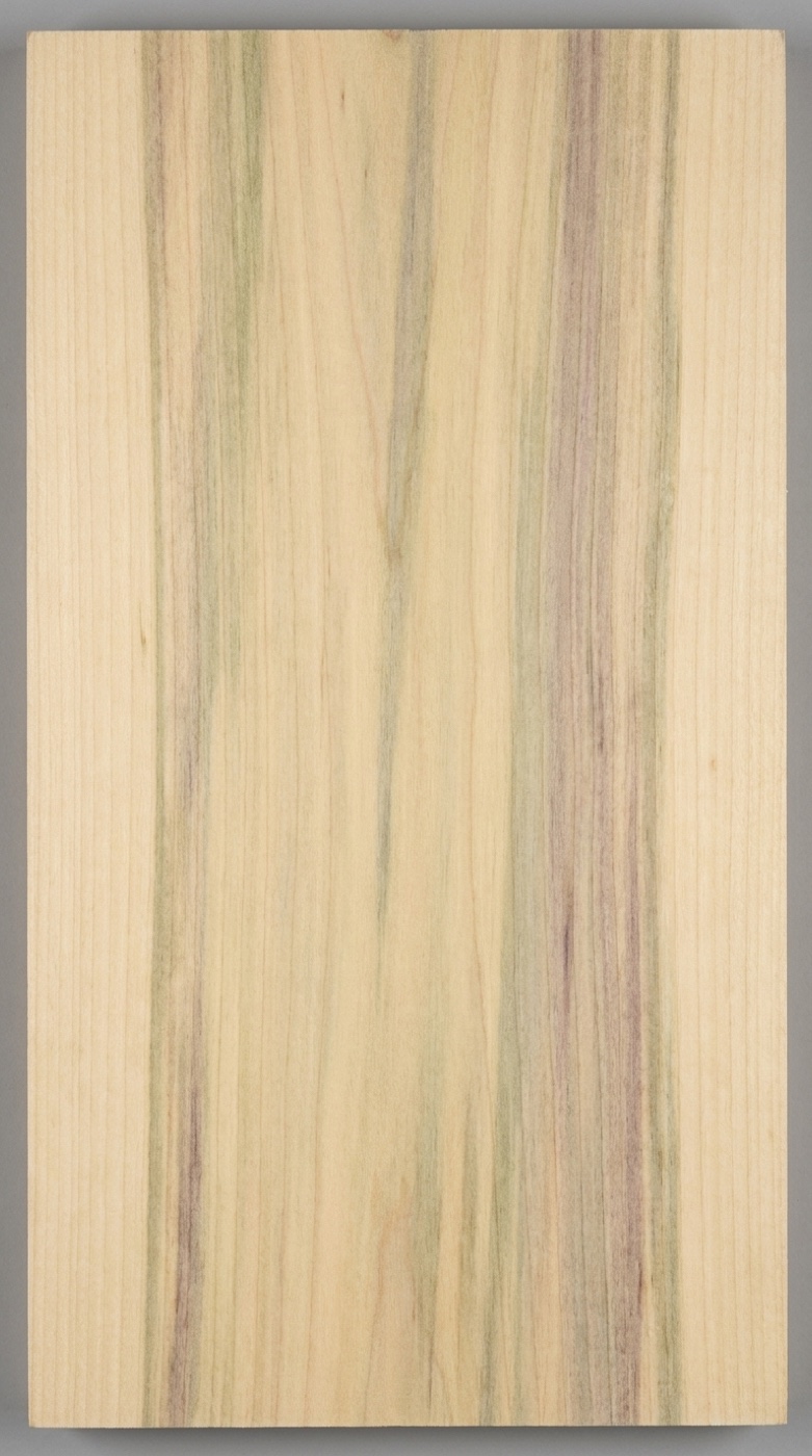A board of yellow poplar -- creamy background with the green and gray mineral streaking the species is known for