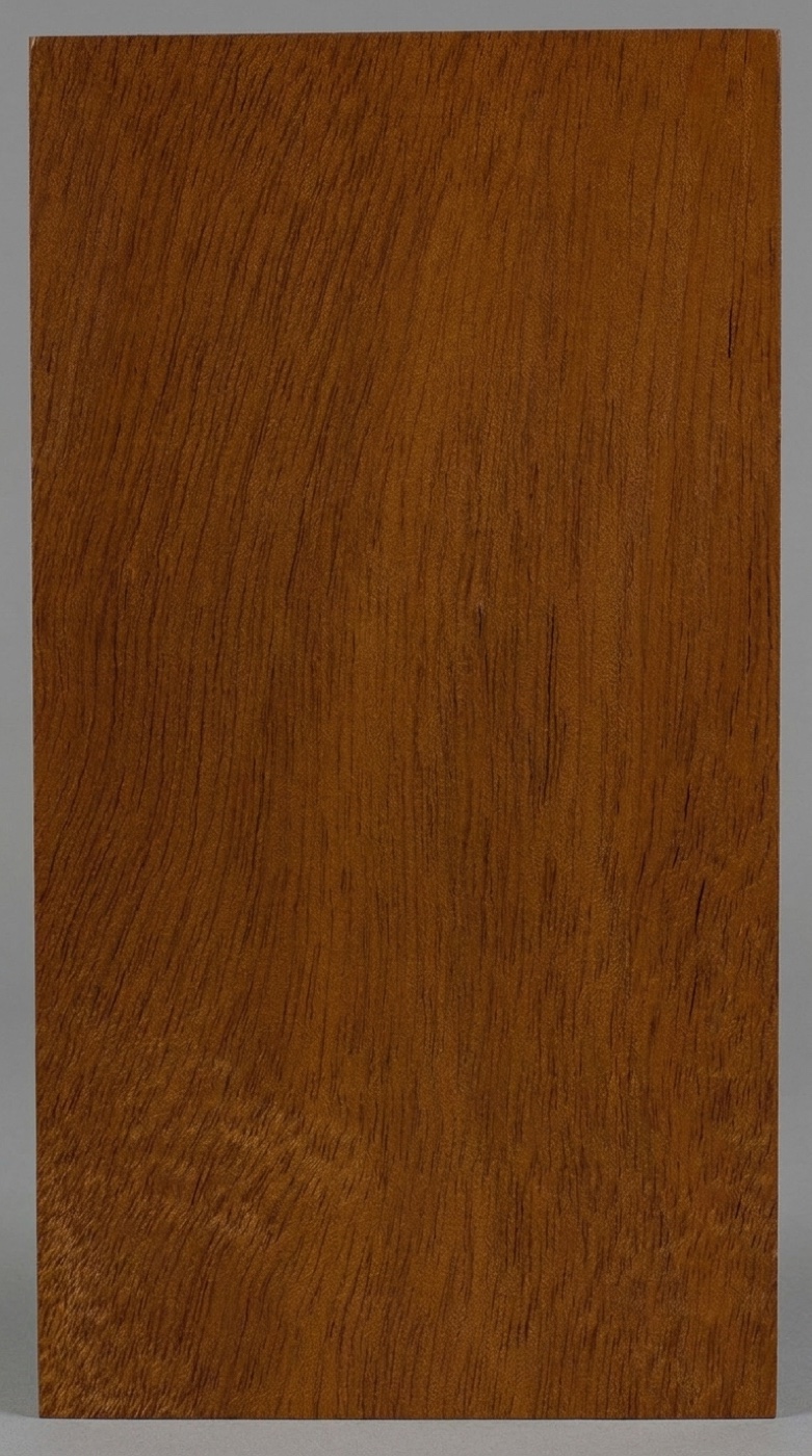 A board of Andiroba (Royal Mahogany) -- medium reddish brown with a subtle ribbon stripe