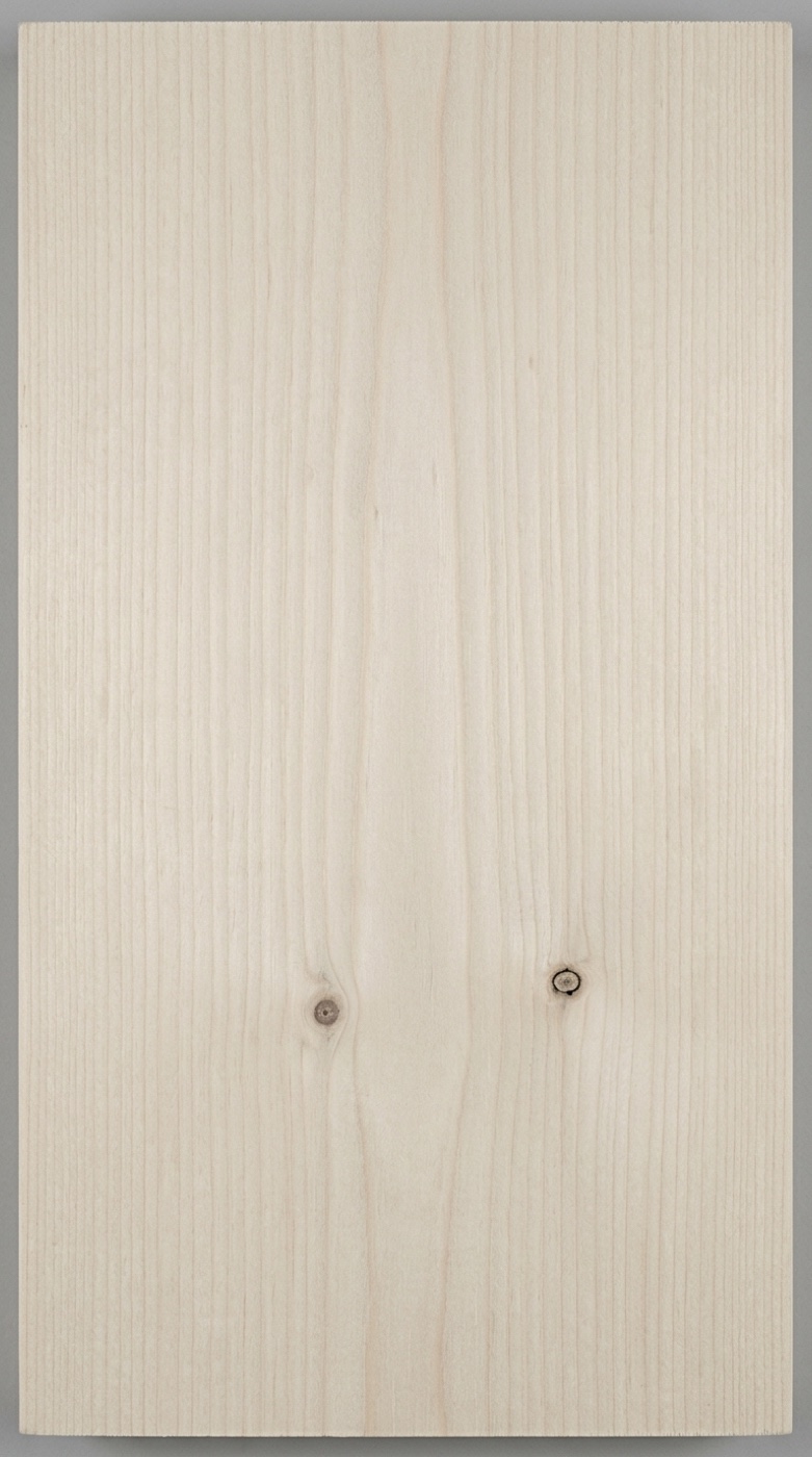 A board of SPF (whitewood) construction lumber -- very pale and slightly cool-toned, fine close grain, with the tight knots ordinary stud grade allows